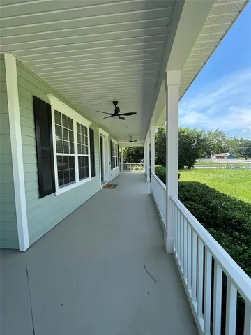 a view of a house with backyard and porch