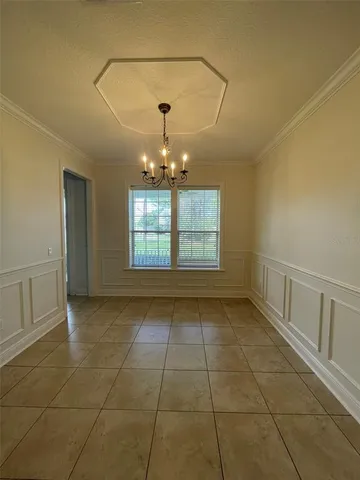 a view of entryway with a window and chandelier
