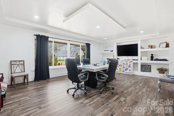 a view of a workspace with furniture and a flat screen tv