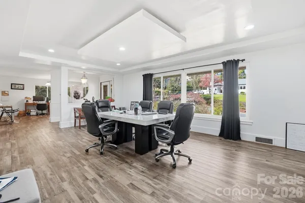 a view of a dining room with furniture window and wooden floor