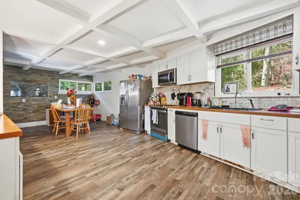 a kitchen with stainless steel appliances granite countertop a refrigerator and sink