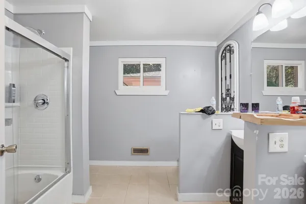 a bathroom with a tub sink and mirror