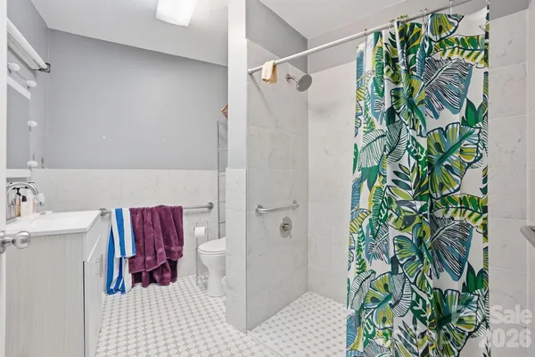 a bathroom with a shower curtain and a sink