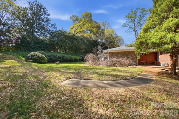 a view of a house with backyard porch and sitting area