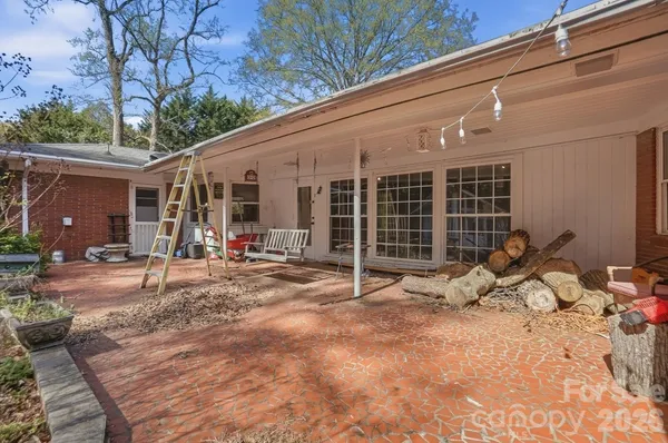 a backyard of a house with table and chairs