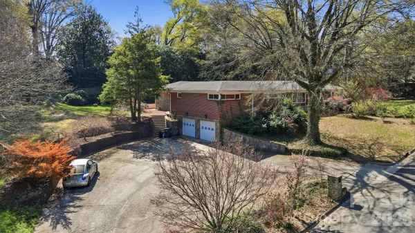a view of a backyard with large trees