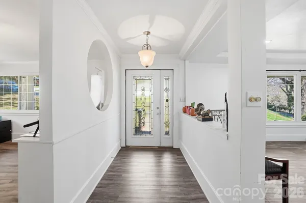 a view of a hallway view with wooden floor and staircase