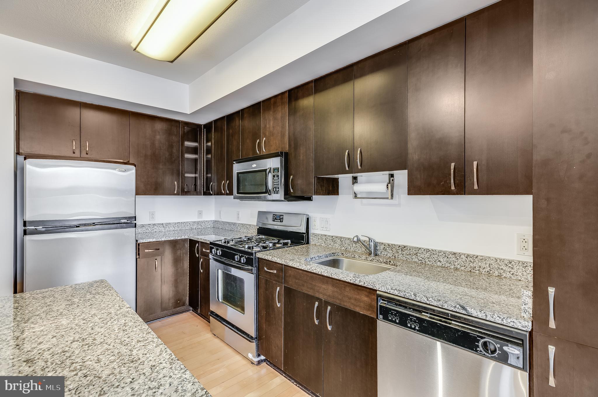 440 L Street Northwest, Unit 913 Washington, DC 20001 - Photo 11 of 42 a kitchen with stainless steel appliances granite countertop a stove a sink and a refrigerator