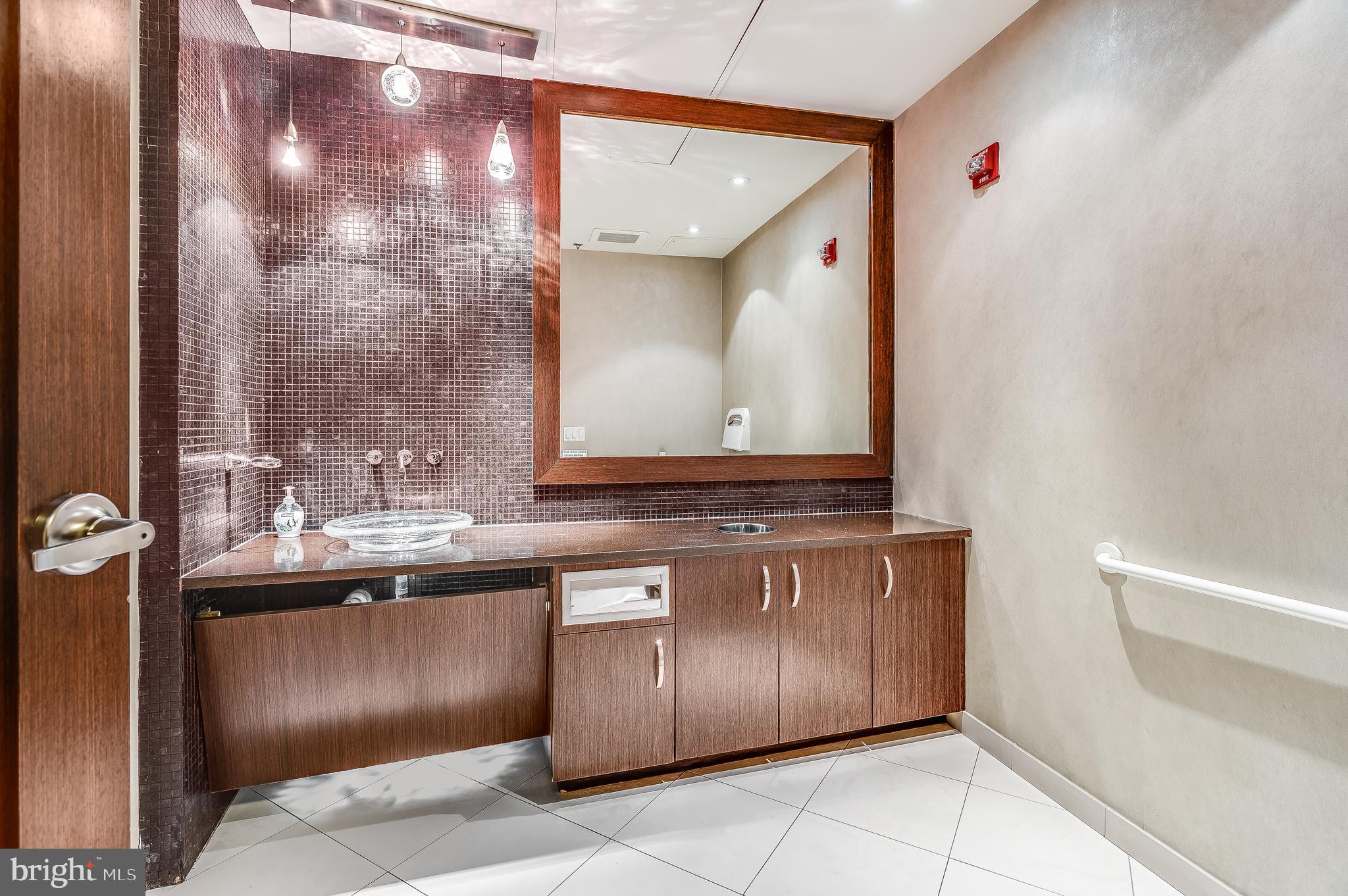 440 L Street Northwest, Unit 913 Washington, DC 20001 - Photo 5 of 42 a bathroom with a sink and a mirror