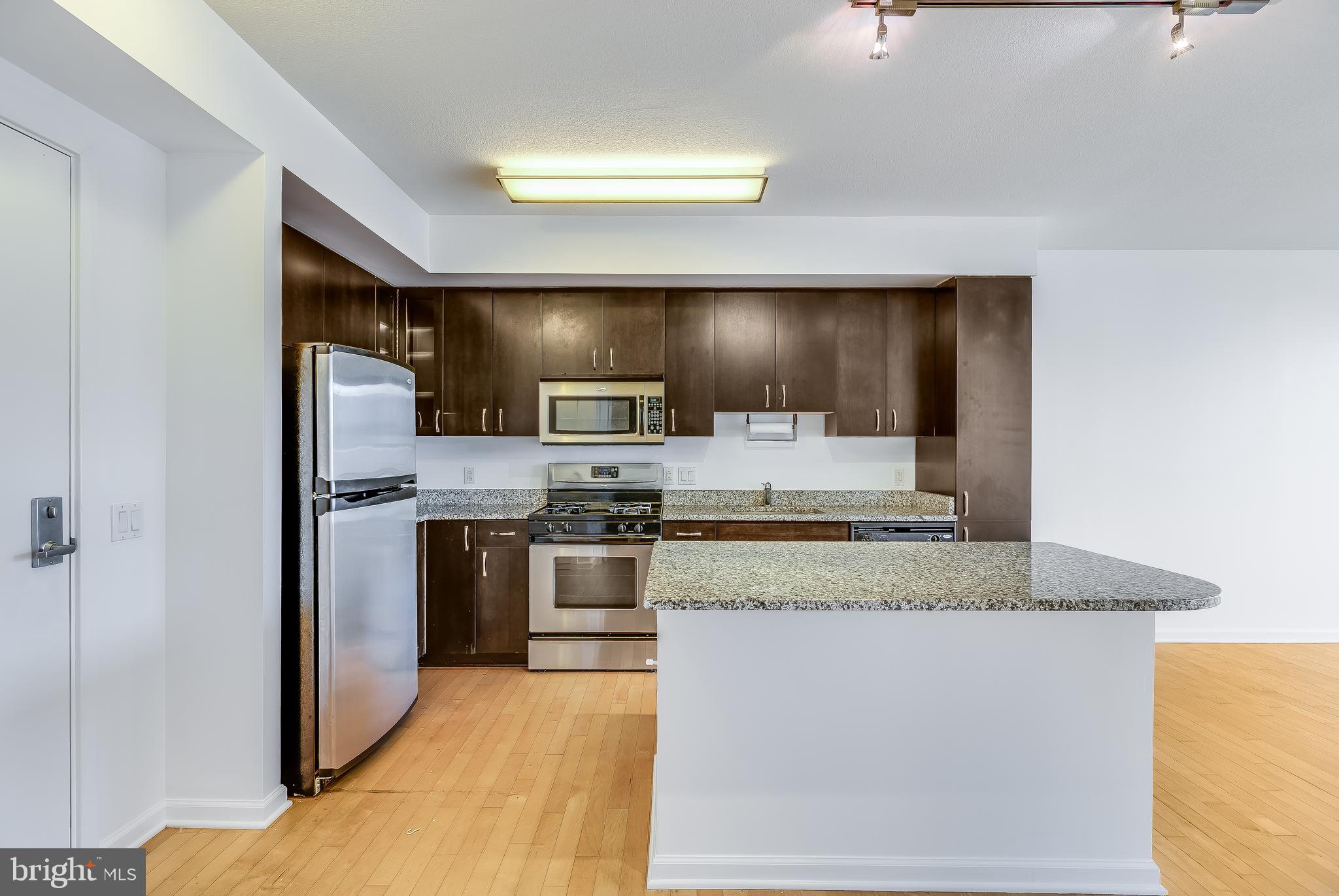 440 L Street Northwest, Unit 913 Washington, DC 20001 - Photo 9 of 42 a kitchen with stainless steel appliances granite countertop a stove a sink and a refrigerator
