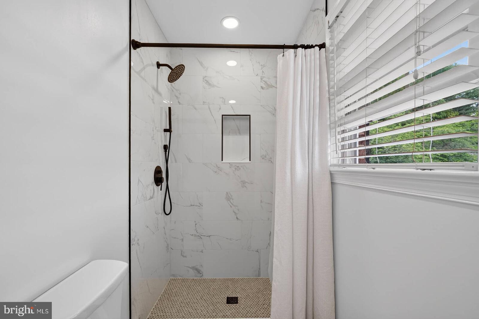 500 Finsbury Road Silver Spring, MD 20904 - Photo 26 of 54 a bathroom with a shower and a sink