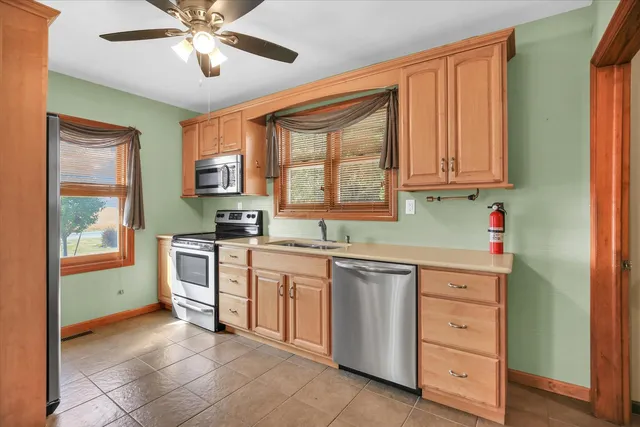 a kitchen with a sink appliances and cabinets