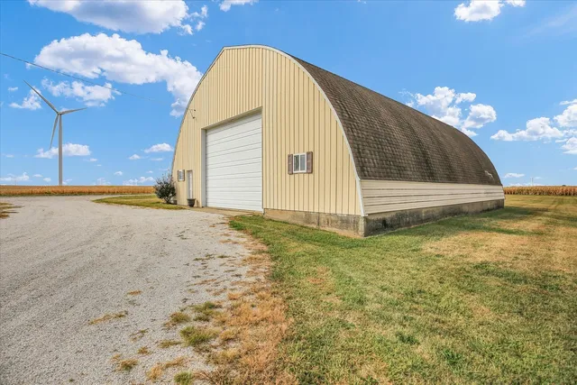 a front view of a house with a yard covered with snow in front of house