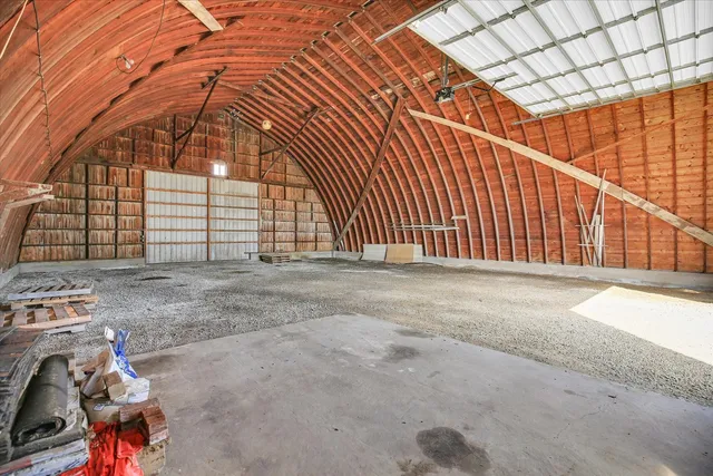 a aerial view of a house with a yard and large tree