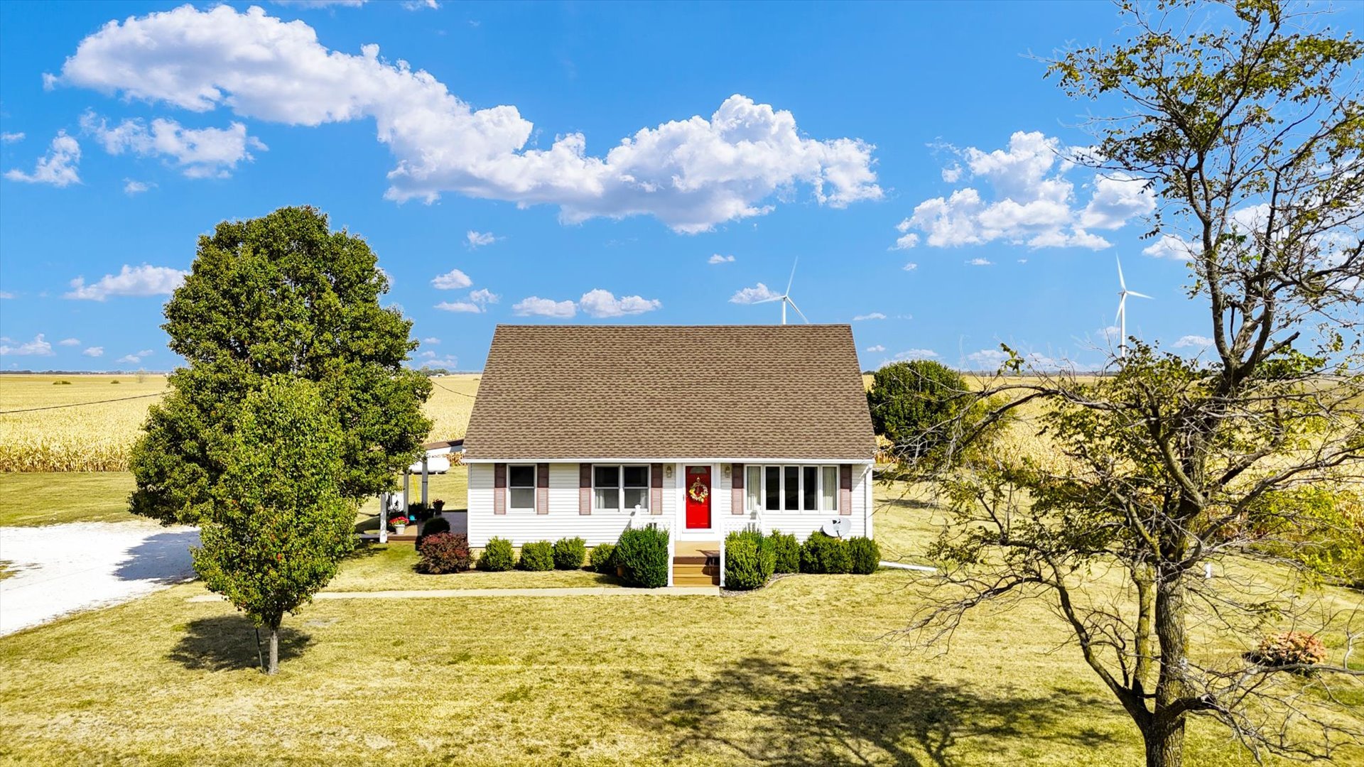 2151 East 2600 North Road Armstrong, IL 61812 - Photo 44 of 56 a front view of a house with a yard covered with snow in front of house