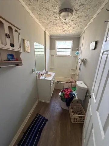 a bathroom with a sink toilet and window