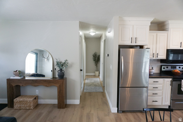 680 Timpie Road Tooele, UT 84074 - Photo 7 of 31 Modern kitchen featuring white cabinetry, stainless steel appliances, dark countertops, and a white subway tile backsplash