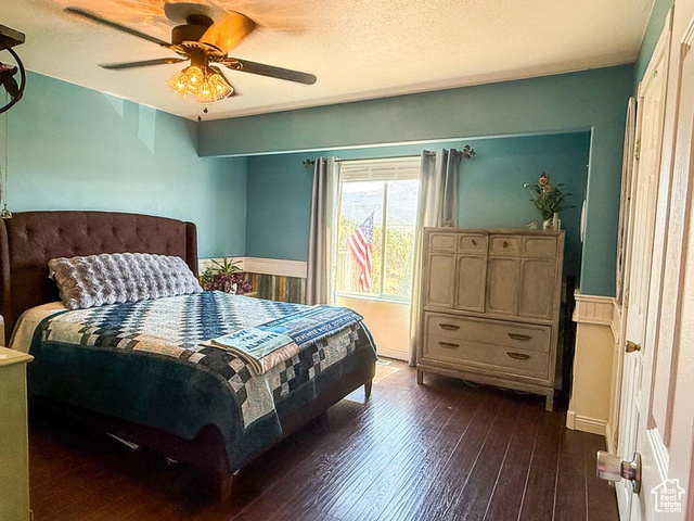 425 East Mule Deer Road Central, UT 84722 - Photo 19 of 72 Bedroom featuring dark wood finished floors, a ceiling fan, and a wainscoted wall