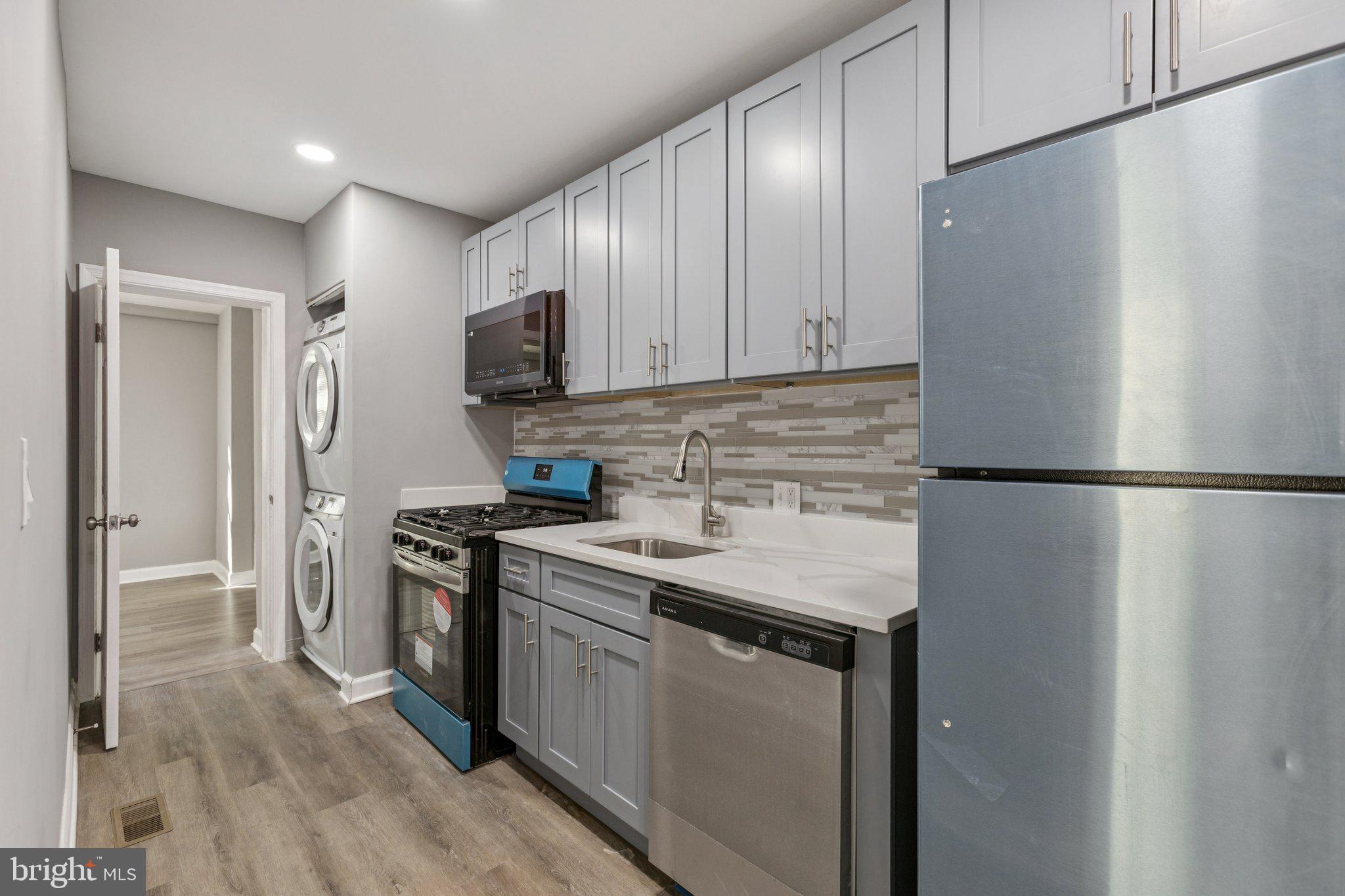 405 34th Street Southeast, Unit 1 Washington, DC 20019 - Photo 11 of 17 a kitchen with stainless steel appliances granite countertop a refrigerator a stove and a sink