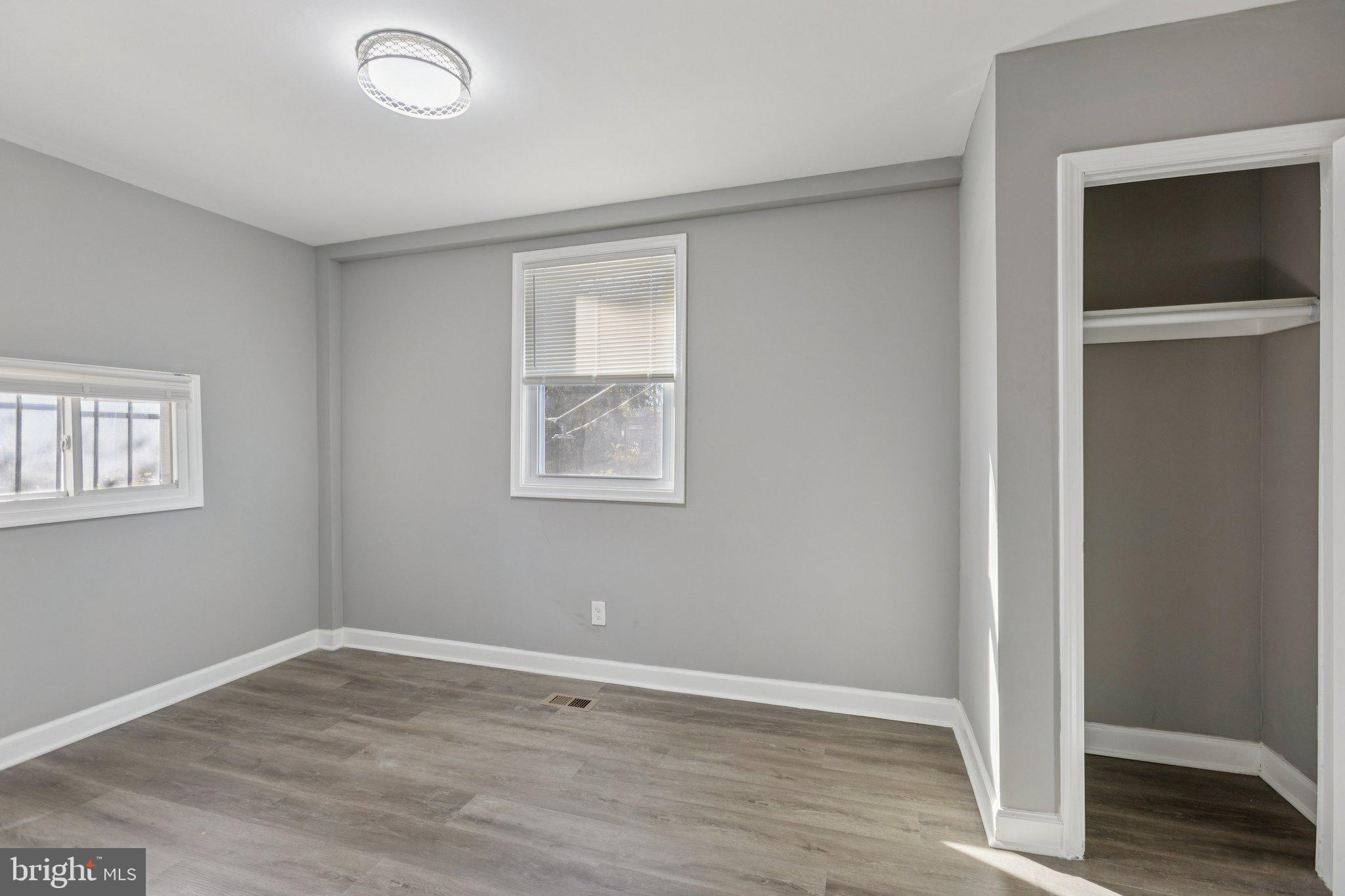 405 34th Street Southeast, Unit 1 Washington, DC 20019 - Photo 12 of 17 an empty room with wooden floor and windows