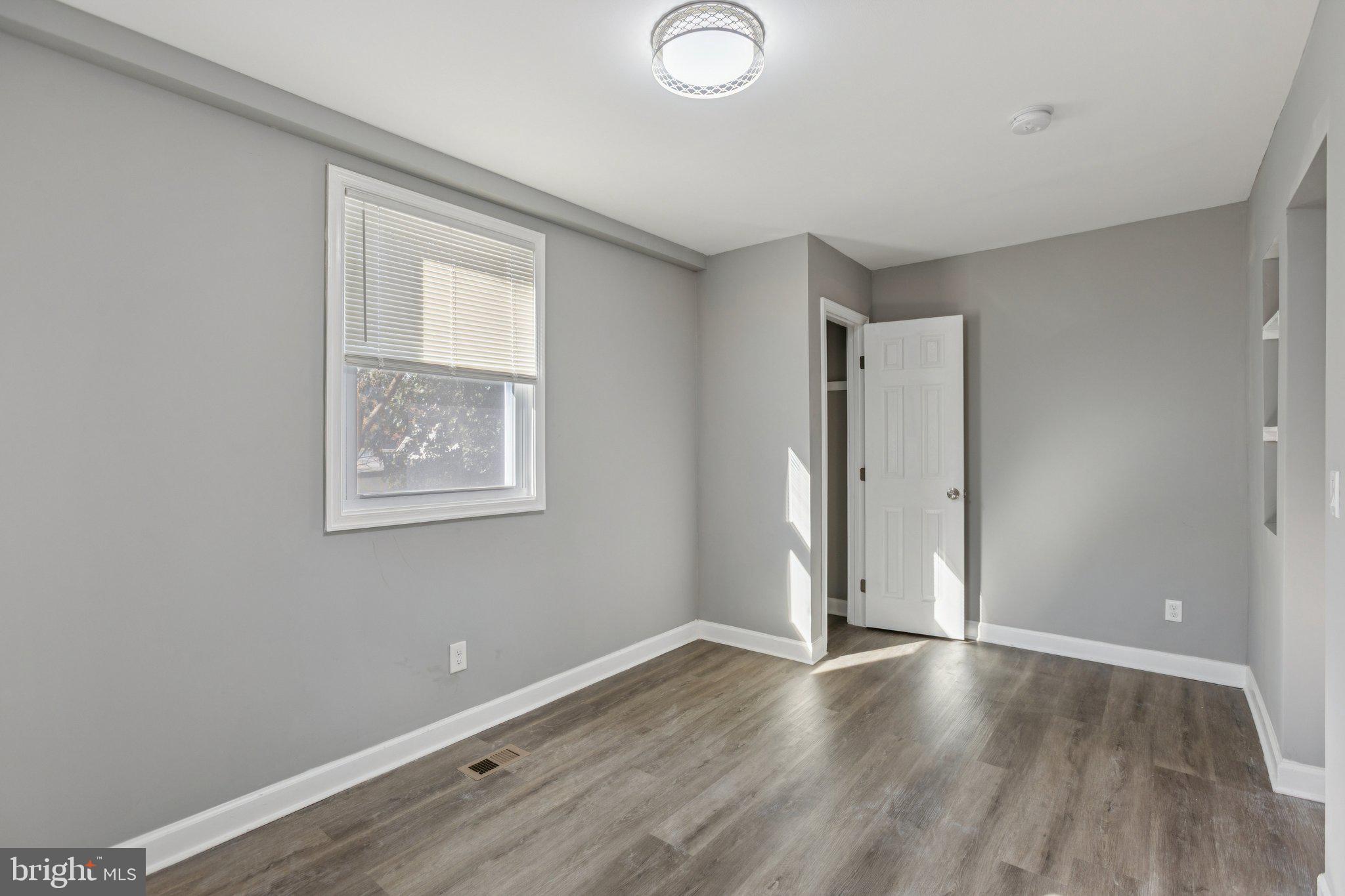 405 34th Street Southeast, Unit 1 Washington, DC 20019 - Photo 13 of 17 an empty room with wooden floor and windows