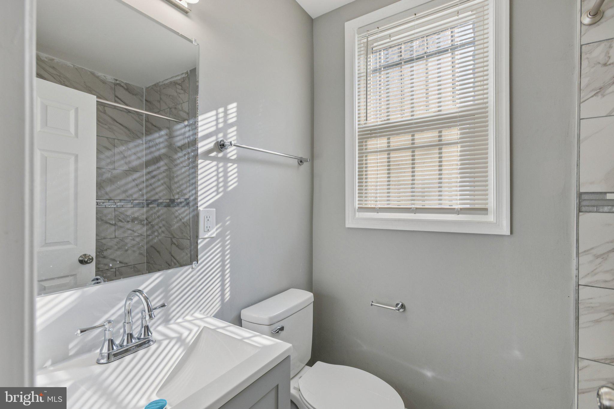 405 34th Street Southeast, Unit 1 Washington, DC 20019 - Photo 14 of 17 a bathroom with a sink toilet and shower