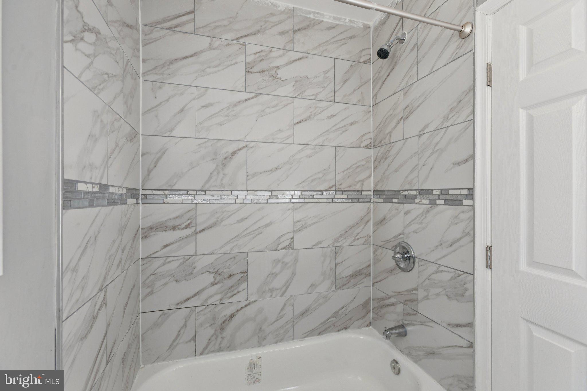 405 34th Street Southeast, Unit 1 Washington, DC 20019 - Photo 16 of 17 a bathroom with a bathtub