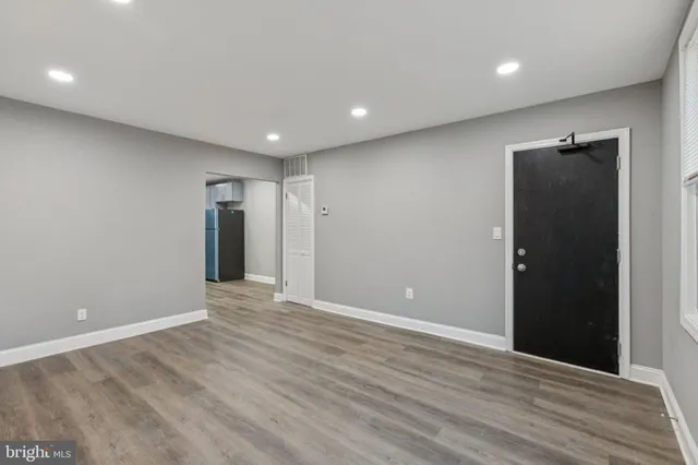 a view of an empty room with wooden floor