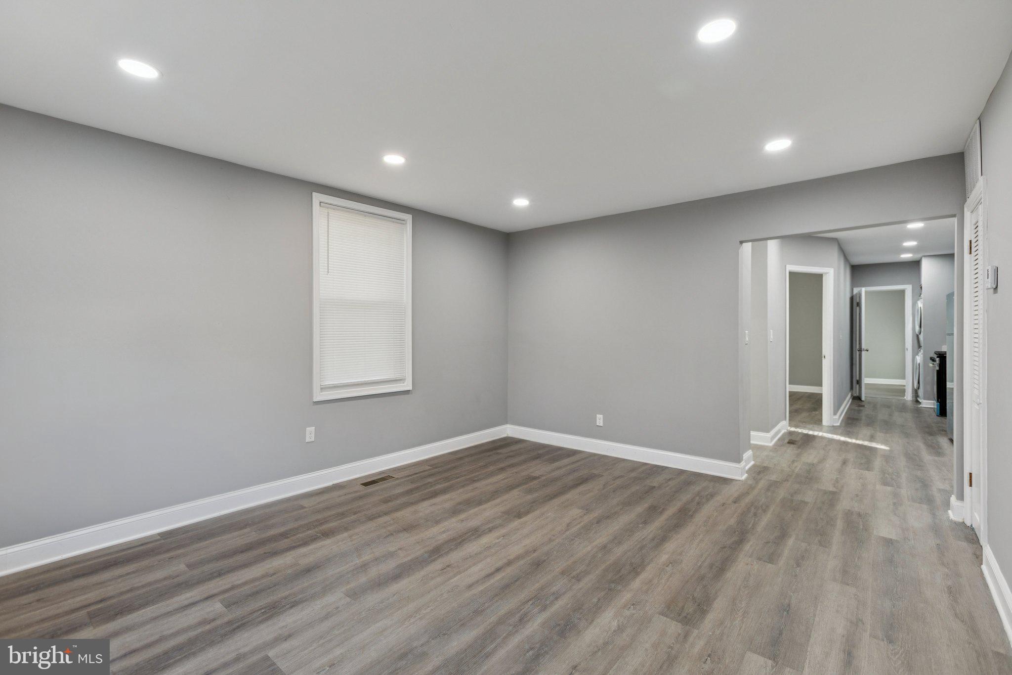 405 34th Street Southeast, Unit 1 Washington, DC 20019 - Photo 5 of 17 an empty room with wooden floor and windows