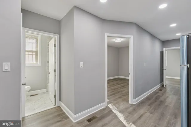 wooden floor with a bedroom and windows