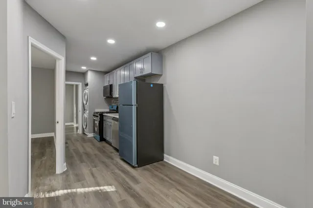 a view of kitchen with refrigerator and window