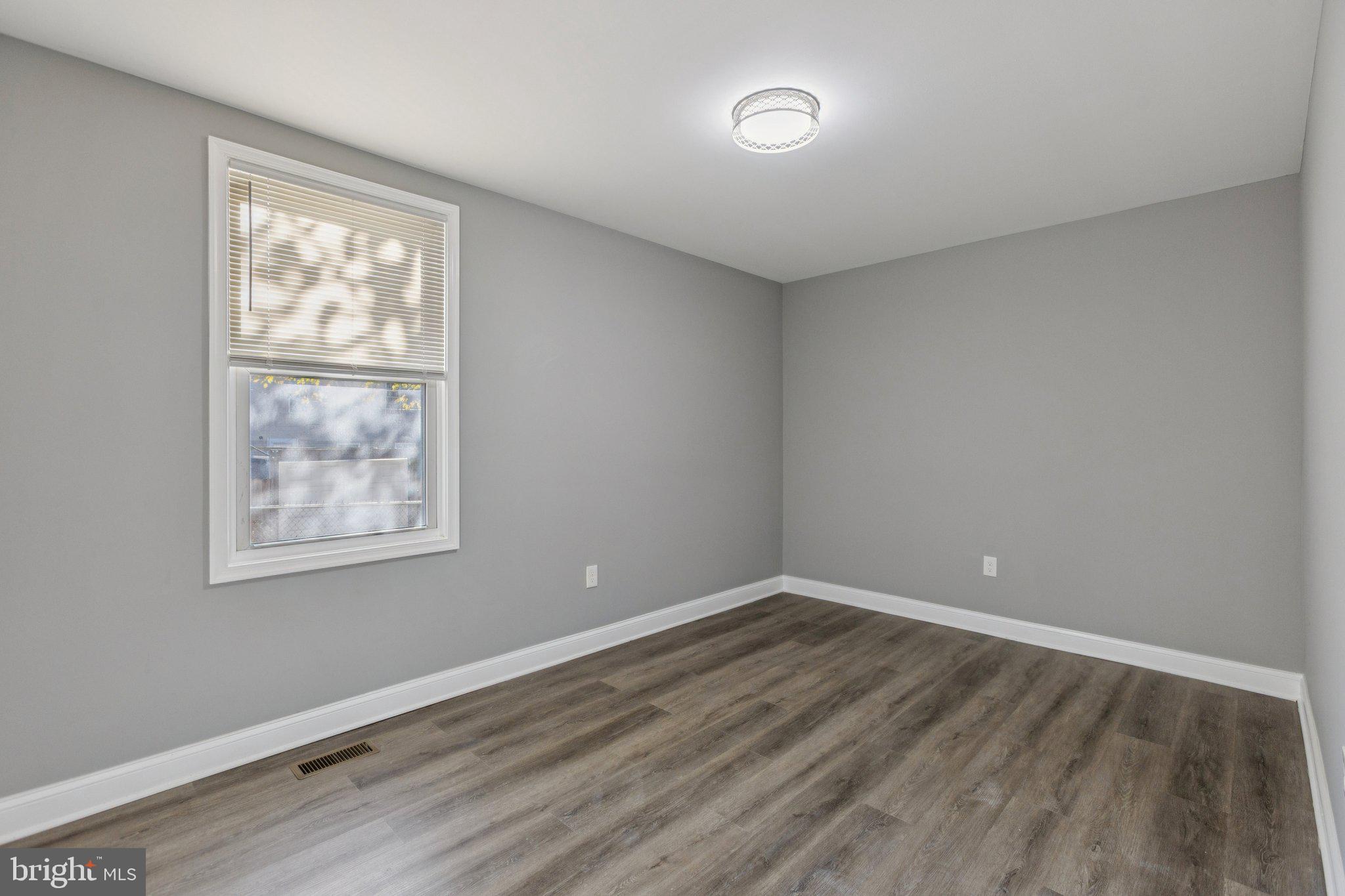 405 34th Street Southeast, Unit 1 Washington, DC 20019 - Photo 9 of 17 a view of an empty room with wooden floor and a window
