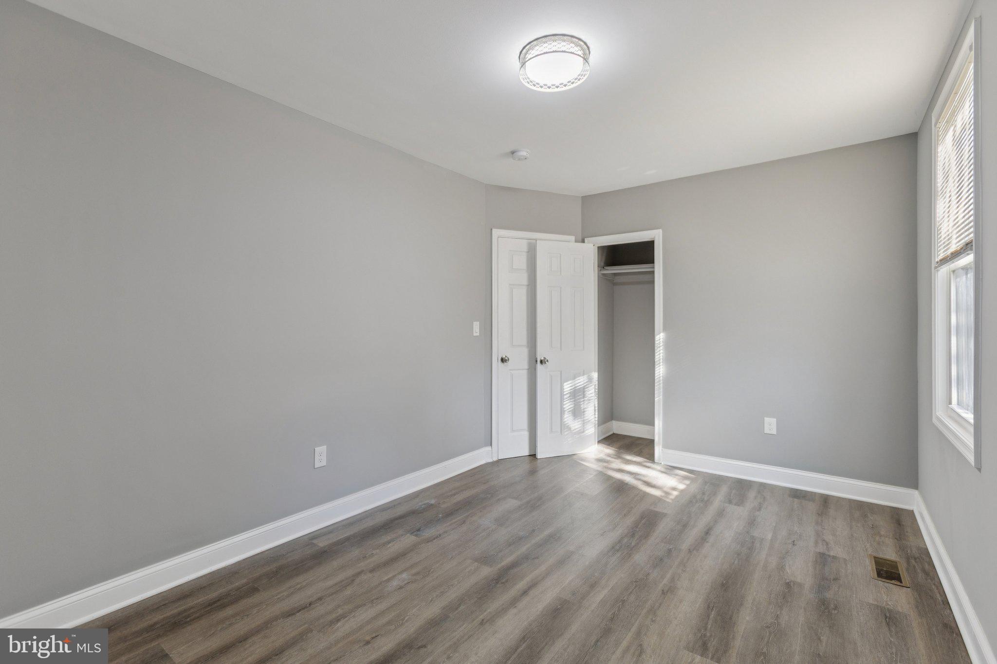 405 34th Street Southeast, Unit 1 Washington, DC 20019 - Photo 10 of 17 an empty room with wooden floor and windows