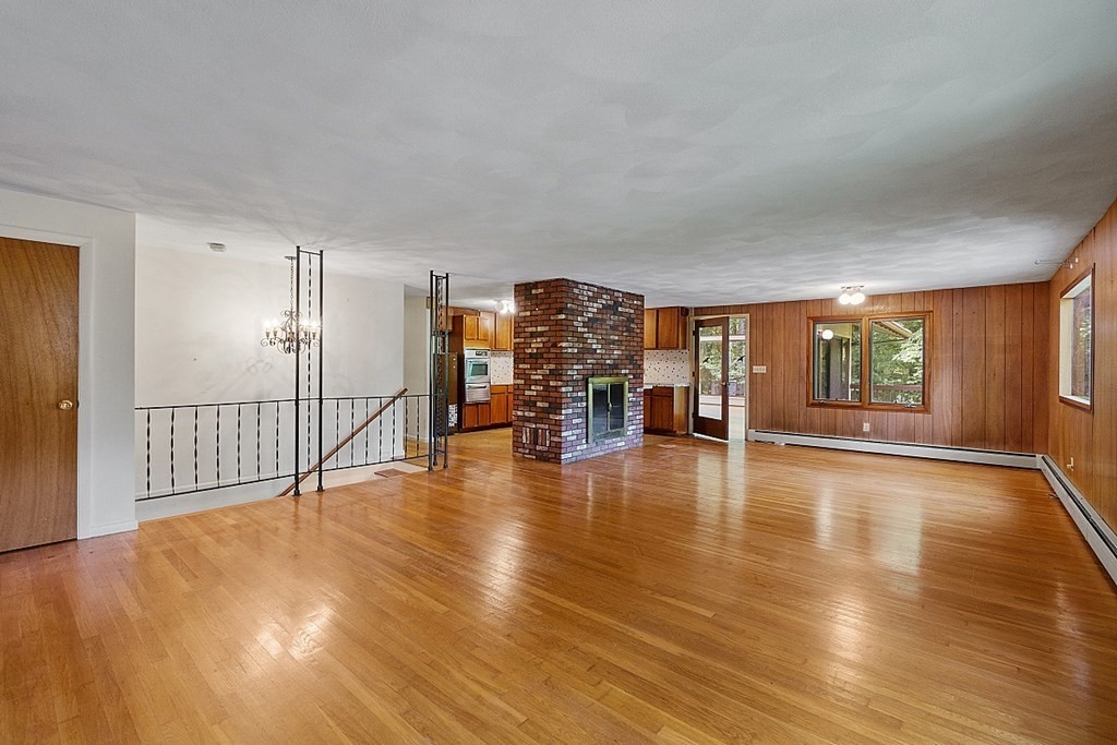 342 Taylor Road Stow, MA 01775 - Photo 13 of 42 a view of empty room with wooden floor and windows