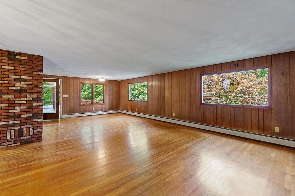 342 Taylor Road Stow, MA 01775 - Photo 15 of 42 an empty room with wooden floor and windows