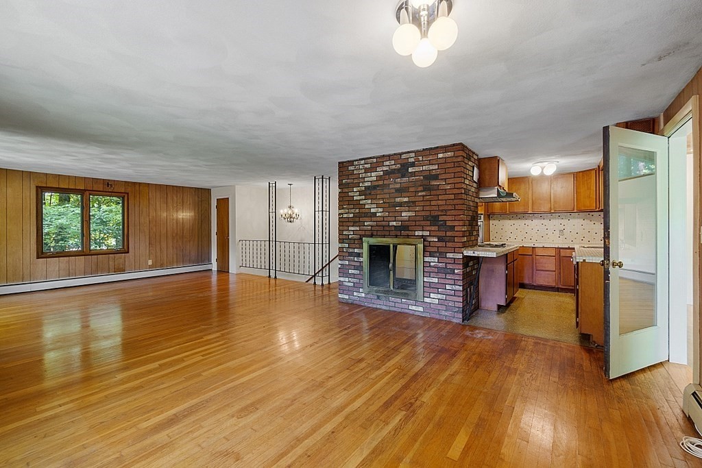342 Taylor Road Stow, MA 01775 - Photo 16 of 42 a view of a livingroom with a fireplace and window