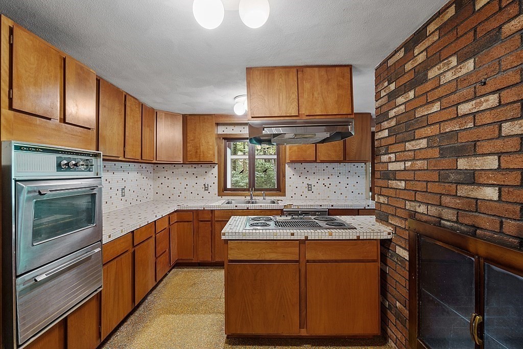 342 Taylor Road Stow, MA 01775 - Photo 17 of 42 a kitchen with stainless steel appliances granite countertop wooden cabinets stove top oven and sink