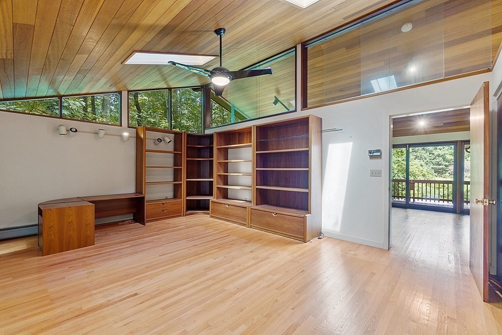 342 Taylor Road Stow, MA 01775 - Photo 23 of 42 an empty room with wooden floor fan and windows