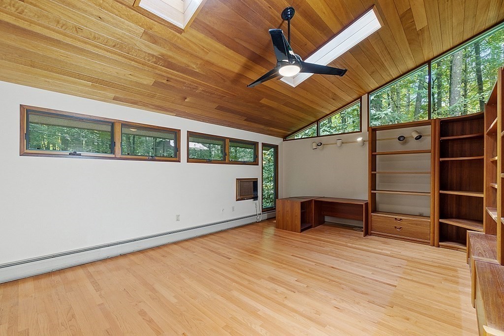 342 Taylor Road Stow, MA 01775 - Photo 25 of 42 a view of a room with wooden floor and a ceiling fan