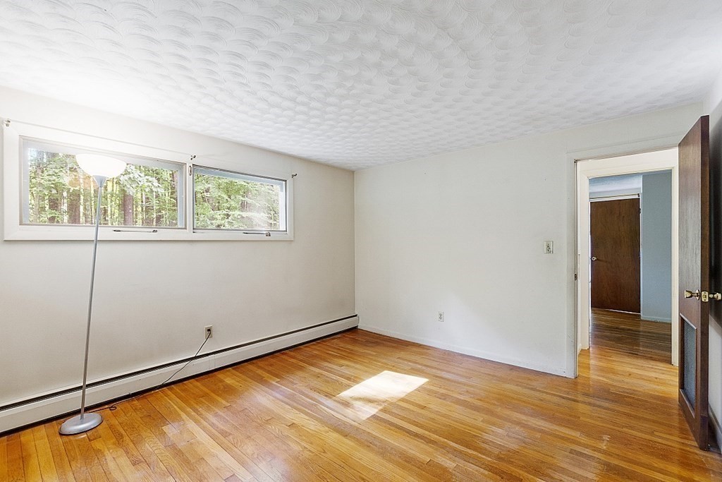 342 Taylor Road Stow, MA 01775 - Photo 32 of 42 an empty room with wooden floor and windows