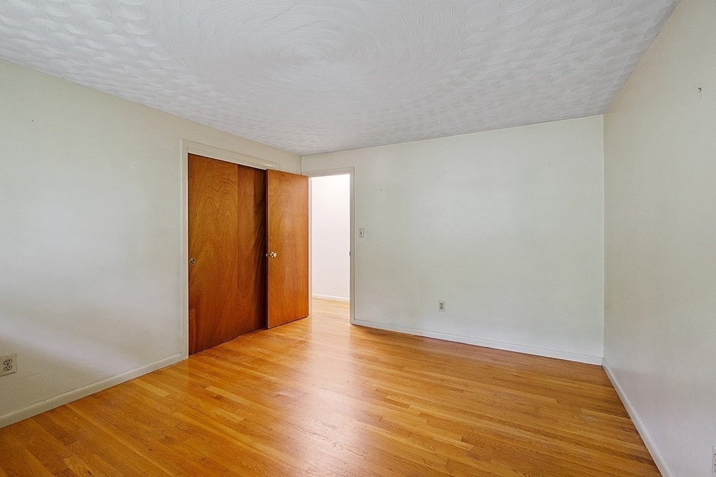 342 Taylor Road Stow, MA 01775 - Photo 34 of 42 a view of an empty room with wooden floor