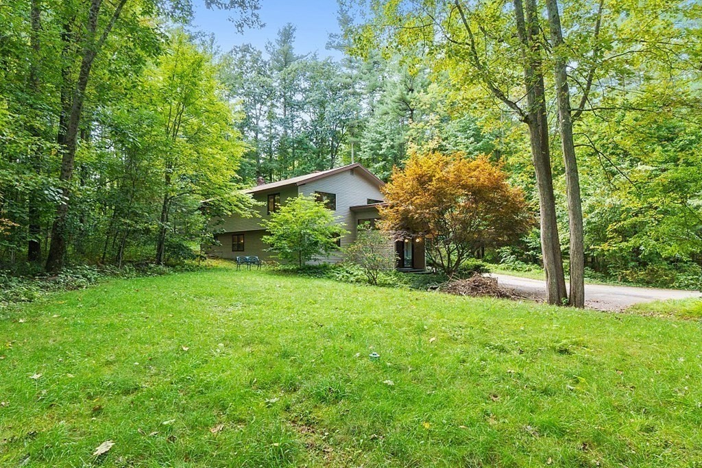 342 Taylor Road Stow, MA 01775 - Photo 40 of 42 a view of a backyard with large trees