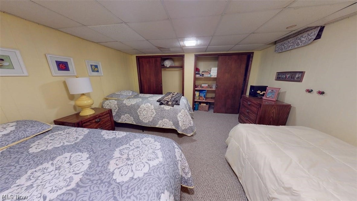 3985 Wiers Road Willard, OH 44890 - Photo 43 of 50 Carpeted room featuring a drop ceiling and yellow-painted walls