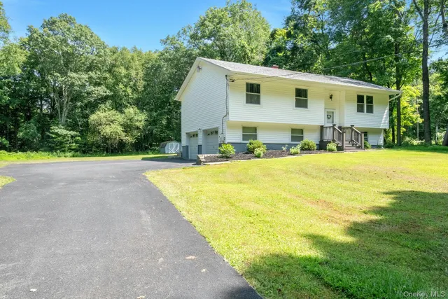 a swimming pool with outdoor seating and yard