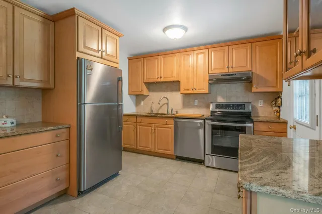 a kitchen with a refrigerator sink and cabinets