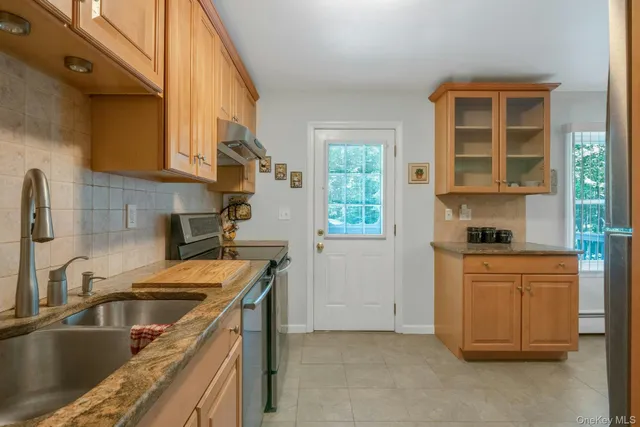 a kitchen that has a sink and a stove in it