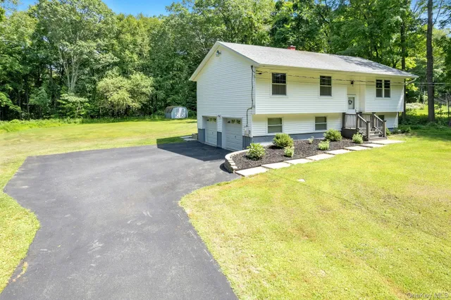 a view of a house with swimming pool and sitting area