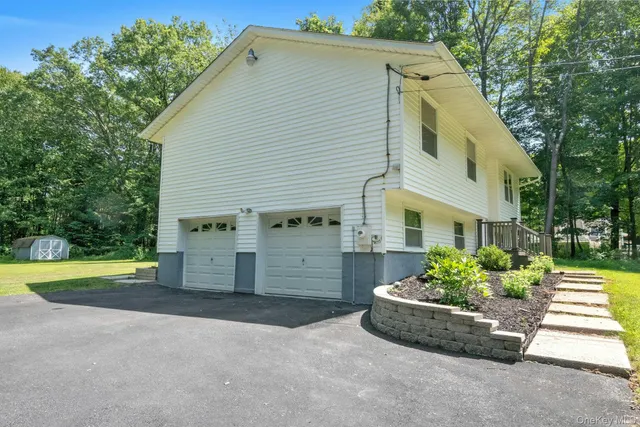 a view of a house with a yard and potted plants