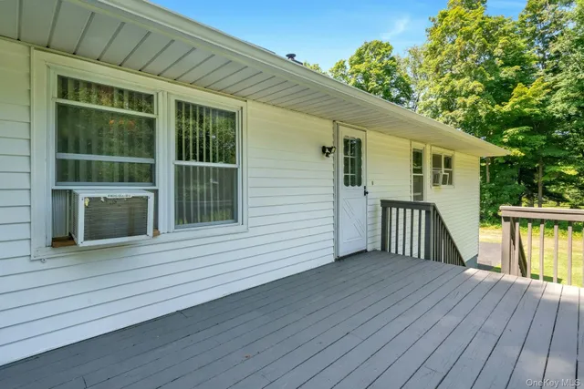 a view of a house with wooden deck