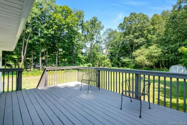 a view of a balcony with wooden floor and fence